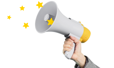 Hand holding loud speaker with yellow stars.